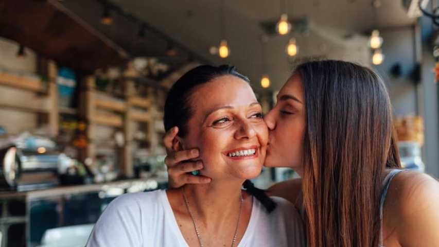 Daughter kisses Mother who has cancer