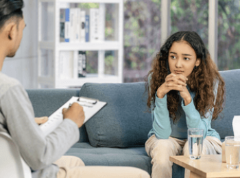 Young woman speaking to specialist