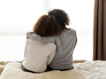 Friends consoling each other