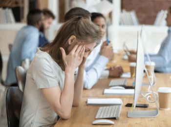 young woman trying to cope at work