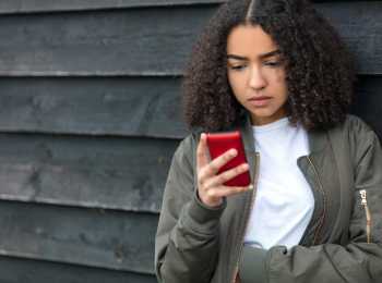Girl looking for information about cancer on phone