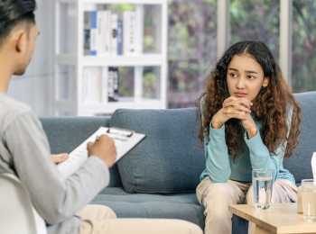 Young woman speaking to specialist