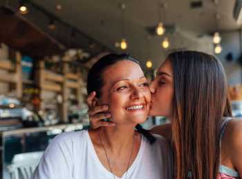 Daughter kisses Mother who has cancer