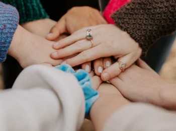 a group of hands joining together as a team